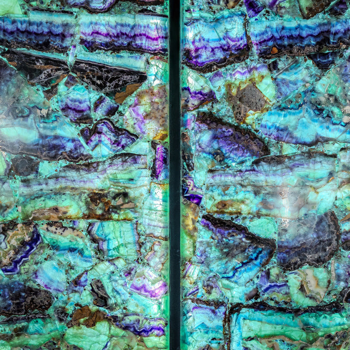 Fluorite crystal wall panels close-up showing turquoise, violet, and green facets with black inclusions