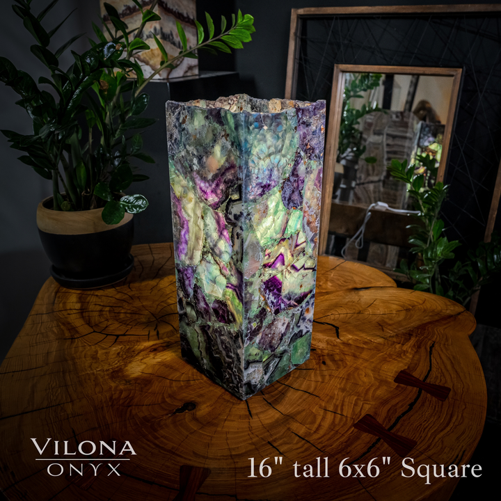 Small fluorite table lamp with faceted multicolor prism shade, on table
