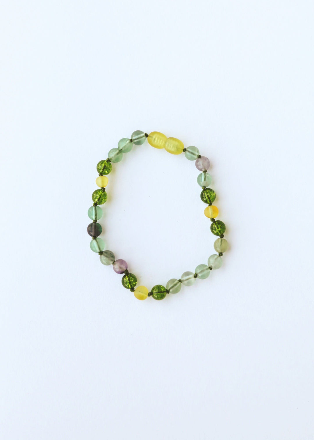 Single gemstone bead necklace with translucent green beads and yellow center charm