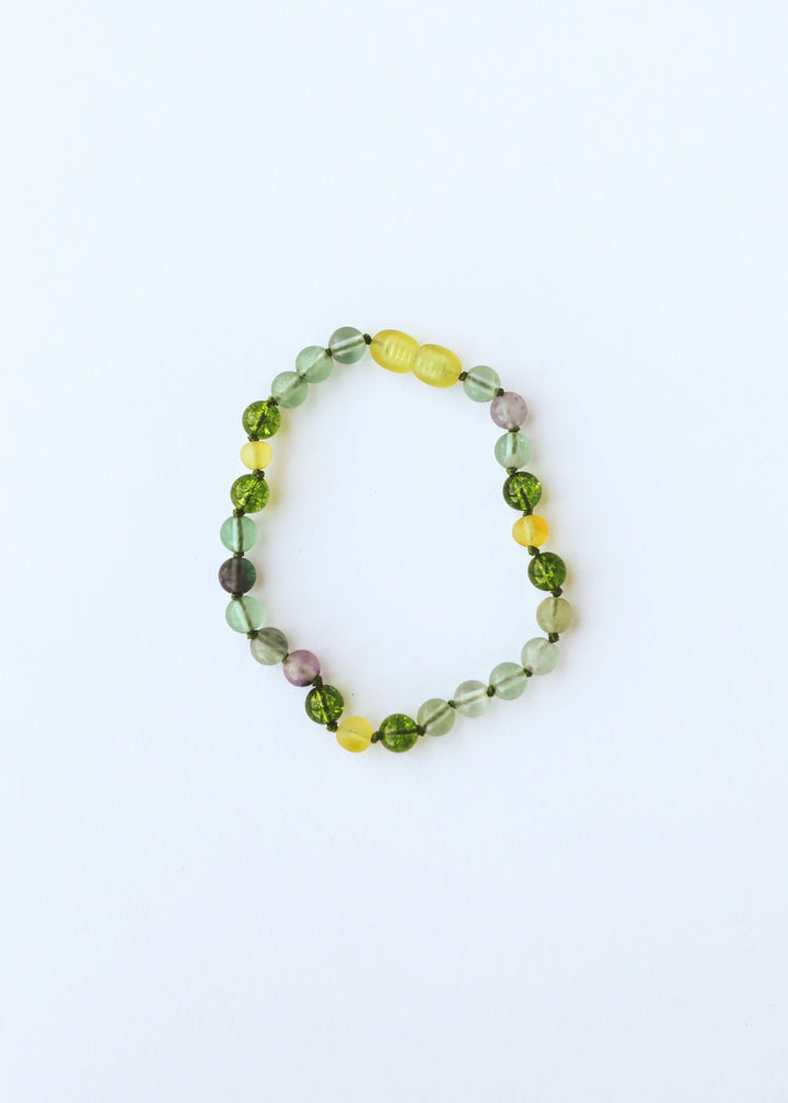 Single gemstone bead necklace with translucent green beads and yellow center charm