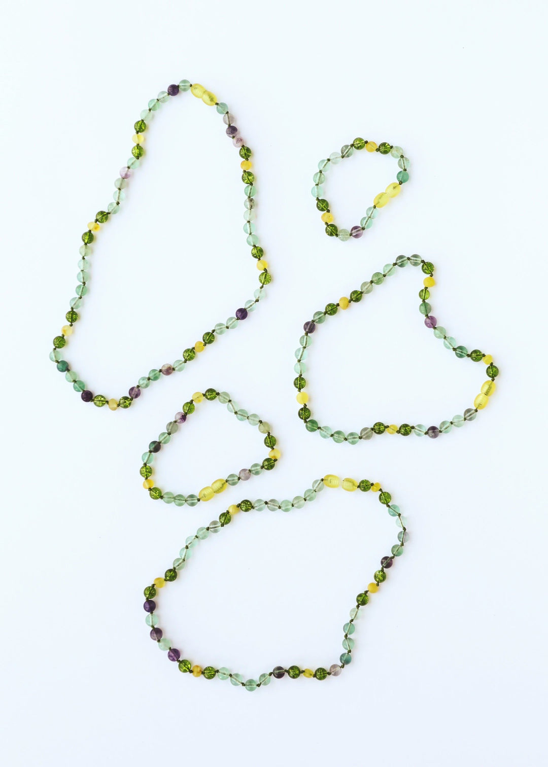 Bead gemstone necklace set: three looping strands in green, yellow, and purple
