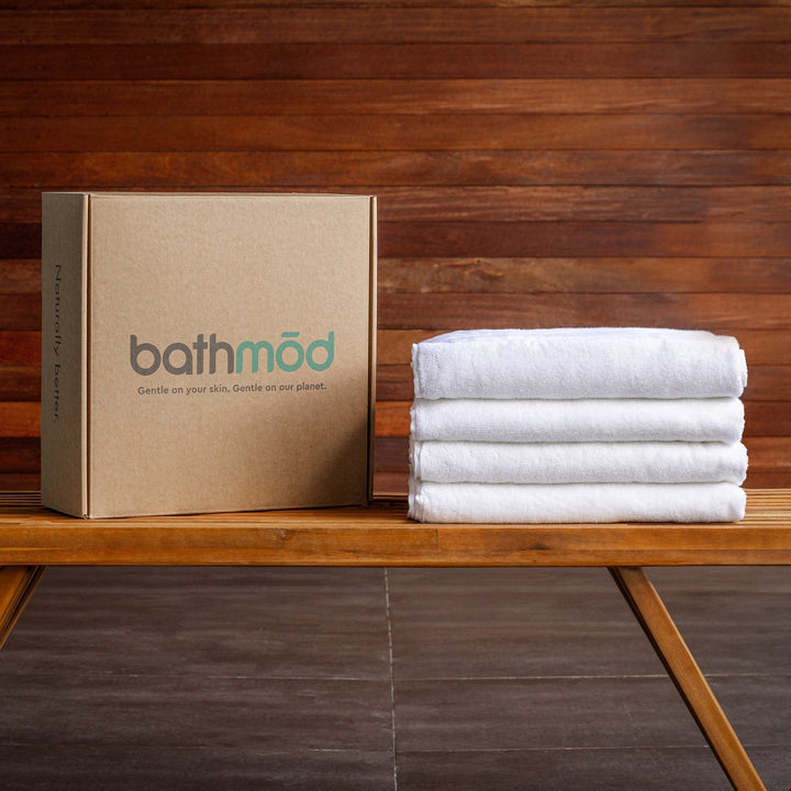 Bath towel set of four white towels with folded stack and kraft gift box