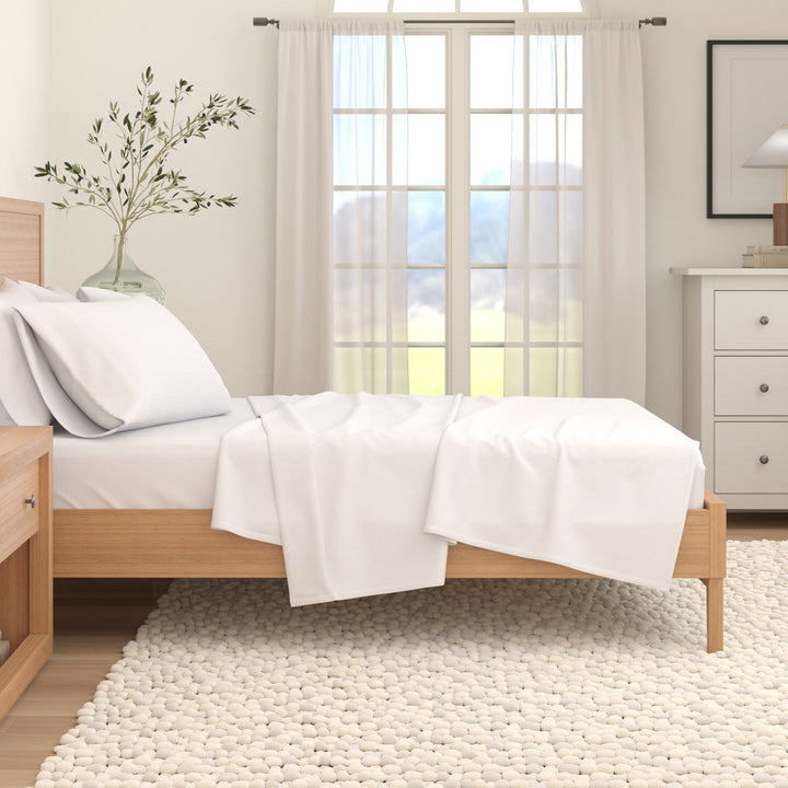 Winter white cotton flannel sheet draped on bed with pillowcases