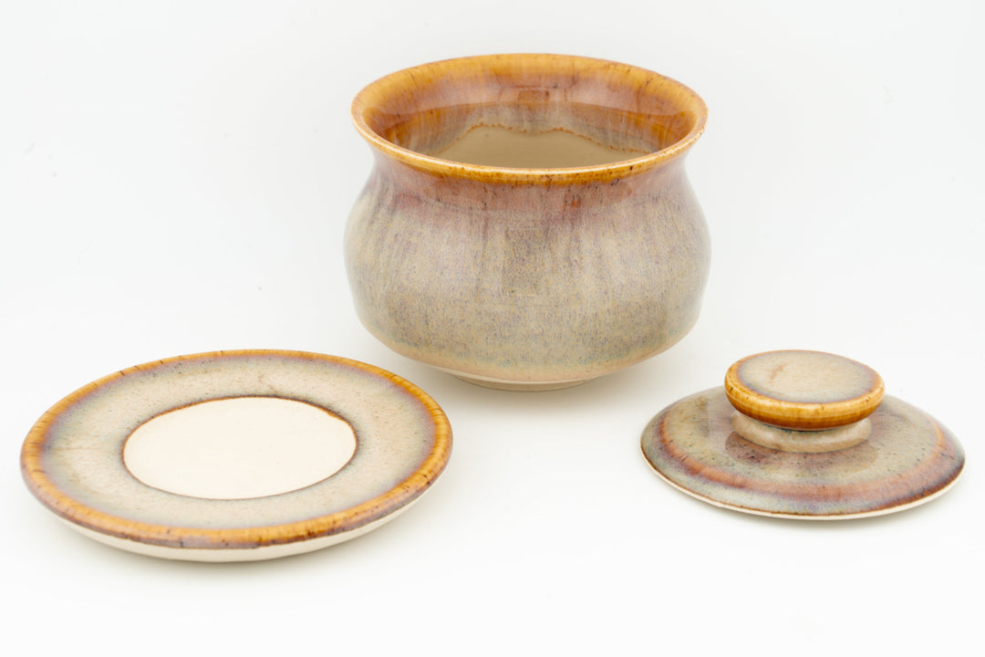 Beige glazed gaiwan with lid, matching saucer, plus small tea cup and saucer.