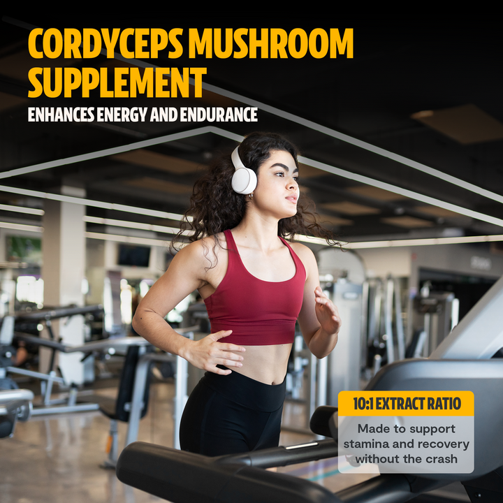 Woman jogging with headphones on treadmill in gym