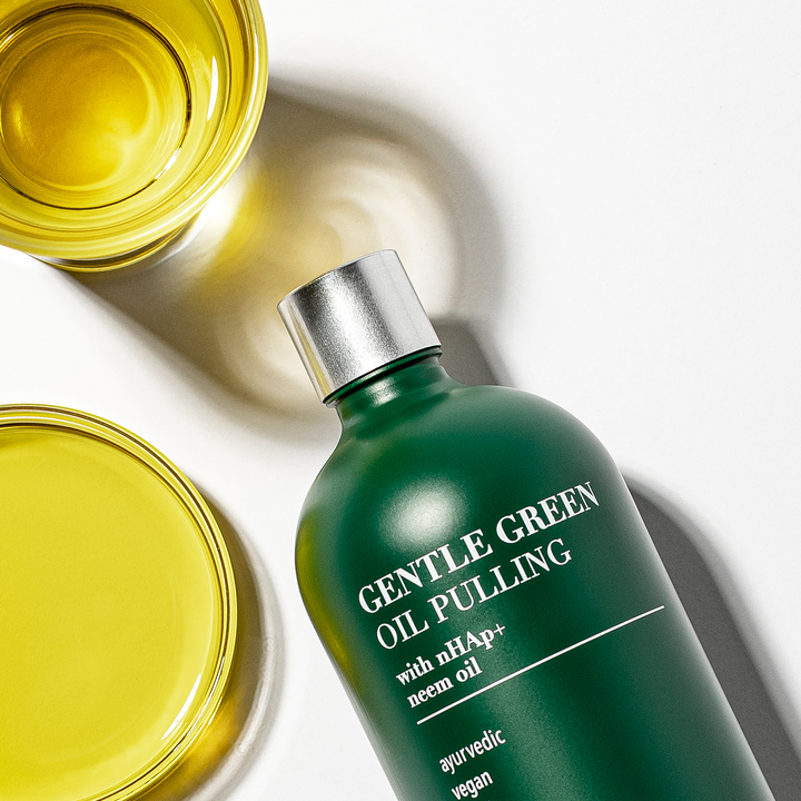 Gentle Green oil pulling oral rinse bottle with teal-green liquid in open jar