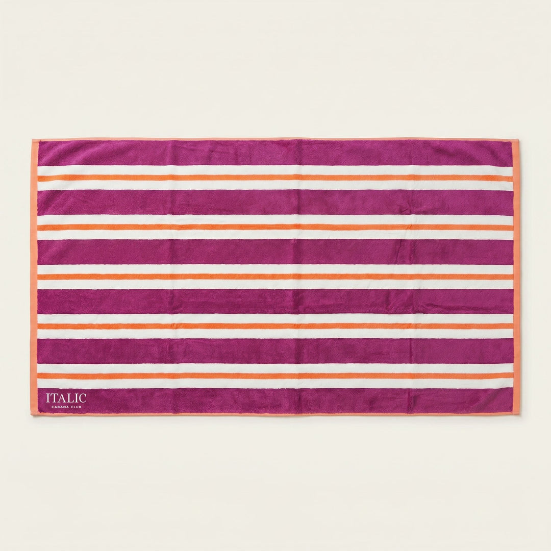 Cotton beach towel with magenta and orange horizontal stripes, ITALIC tag at corner