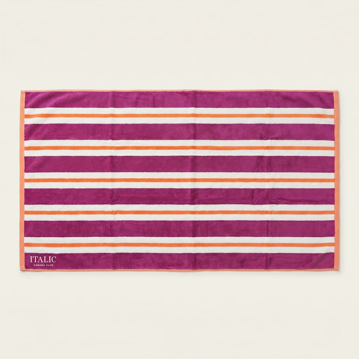 Cotton beach towel with magenta and orange horizontal stripes, ITALIC tag at corner