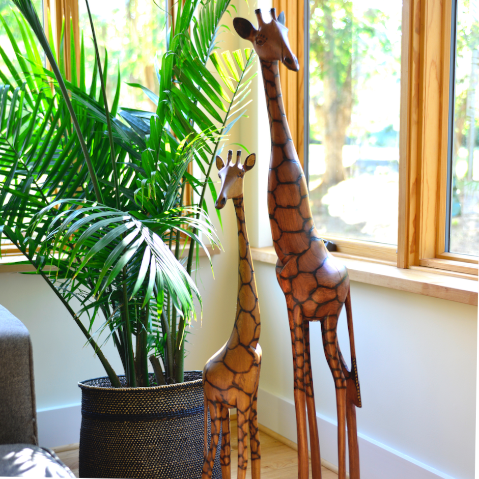 Olivewood giraffe figurine with long legs and carved patterned body on base