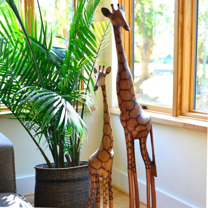 Olivewood giraffe figurine with long legs and carved patterned body on base
