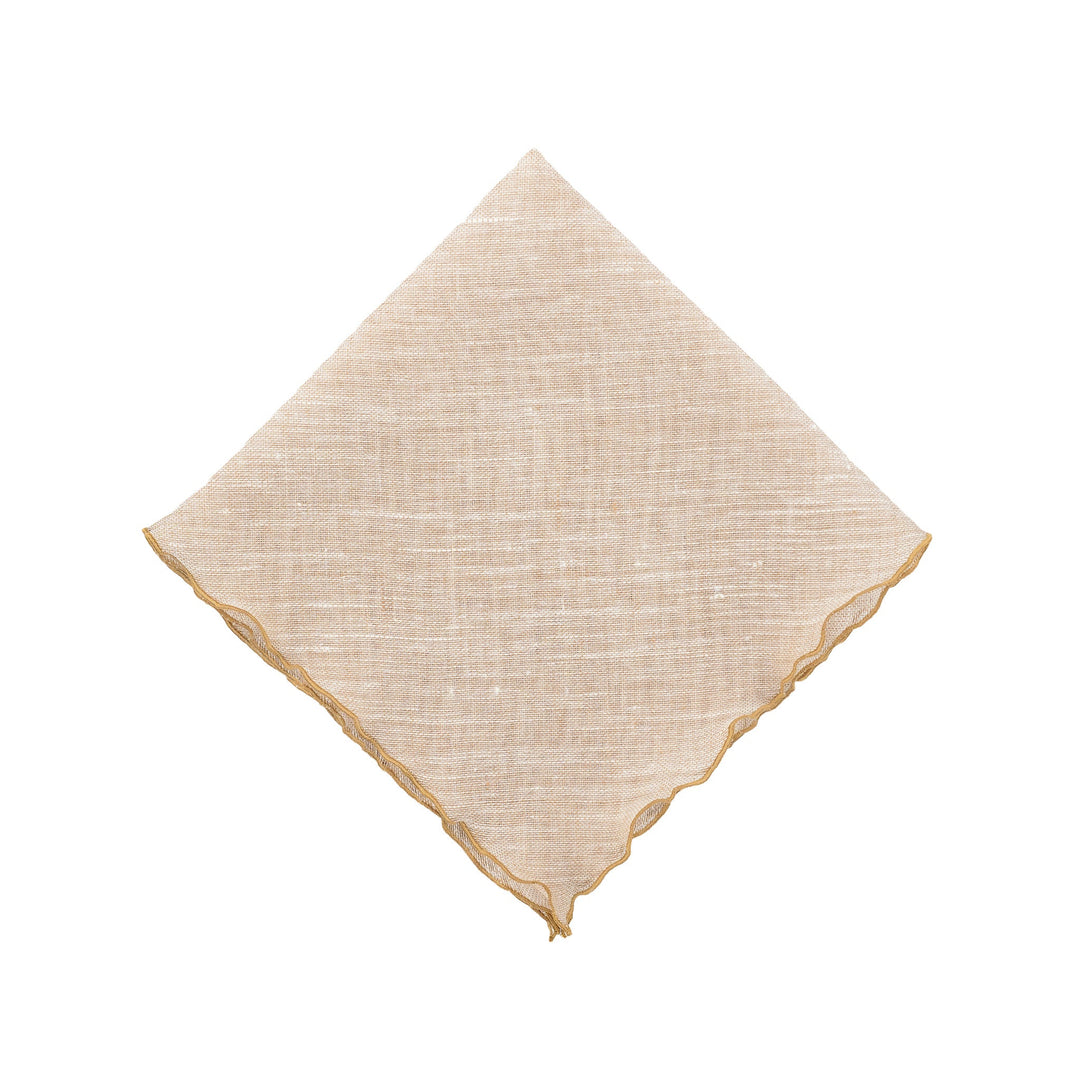 Beige linen napkin with gold ruffled edges, neatly folded square