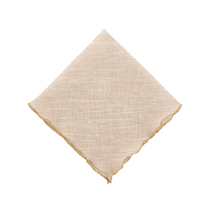 Beige linen napkin with gold ruffled edges, neatly folded square