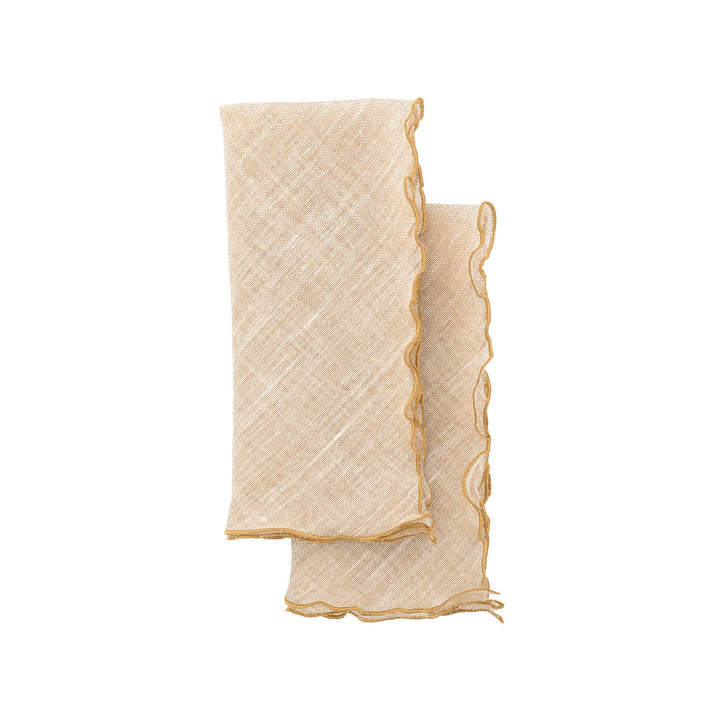 Beige linen napkin with gold ruffled edges, stacked folded corners