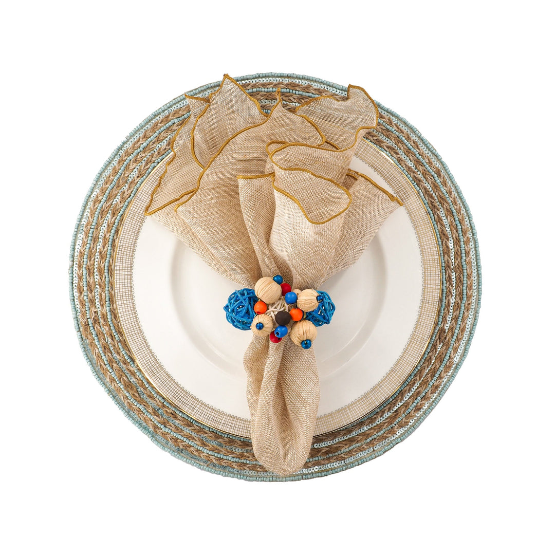 Beige linen napkin with gold trim and beaded ribbon tie