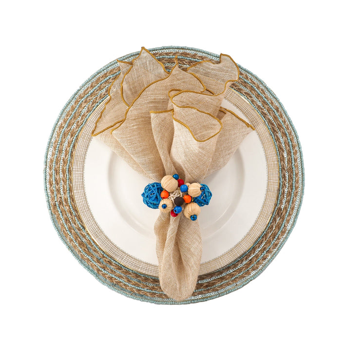 Beige linen napkin with gold trim and beaded ribbon tie