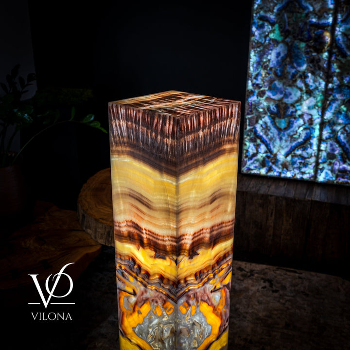 Square floor lamp with glowing amber onyx-style shade and dark brown accents