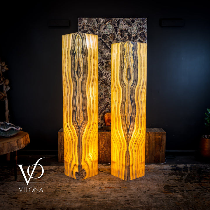 Pair of onyx floor lamps with glowing amber interior and tall square-top rectangular shades