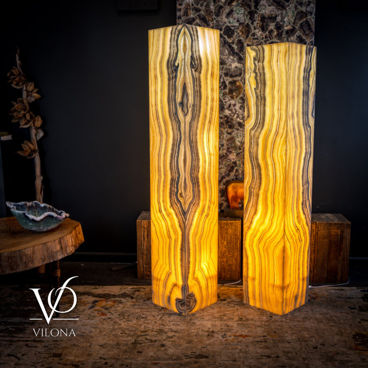 Pair of onyx floor lamps with amber glow, textured vertical stripes on square-top shades