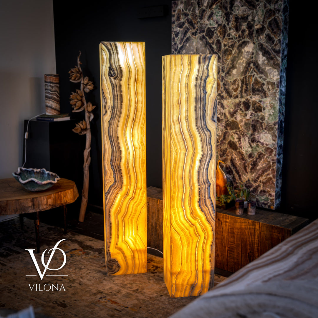 Pair of large onyx floor lamps with amber glow, vertically veined rectangular shades