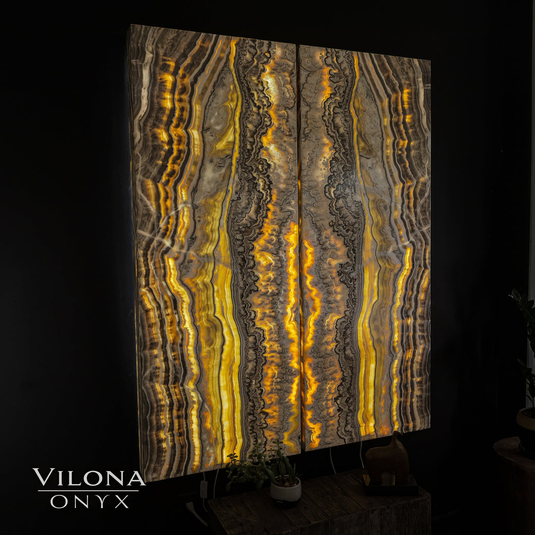 Onyx wall panel displayed with vertical gold and gray wavy onyx layers.
