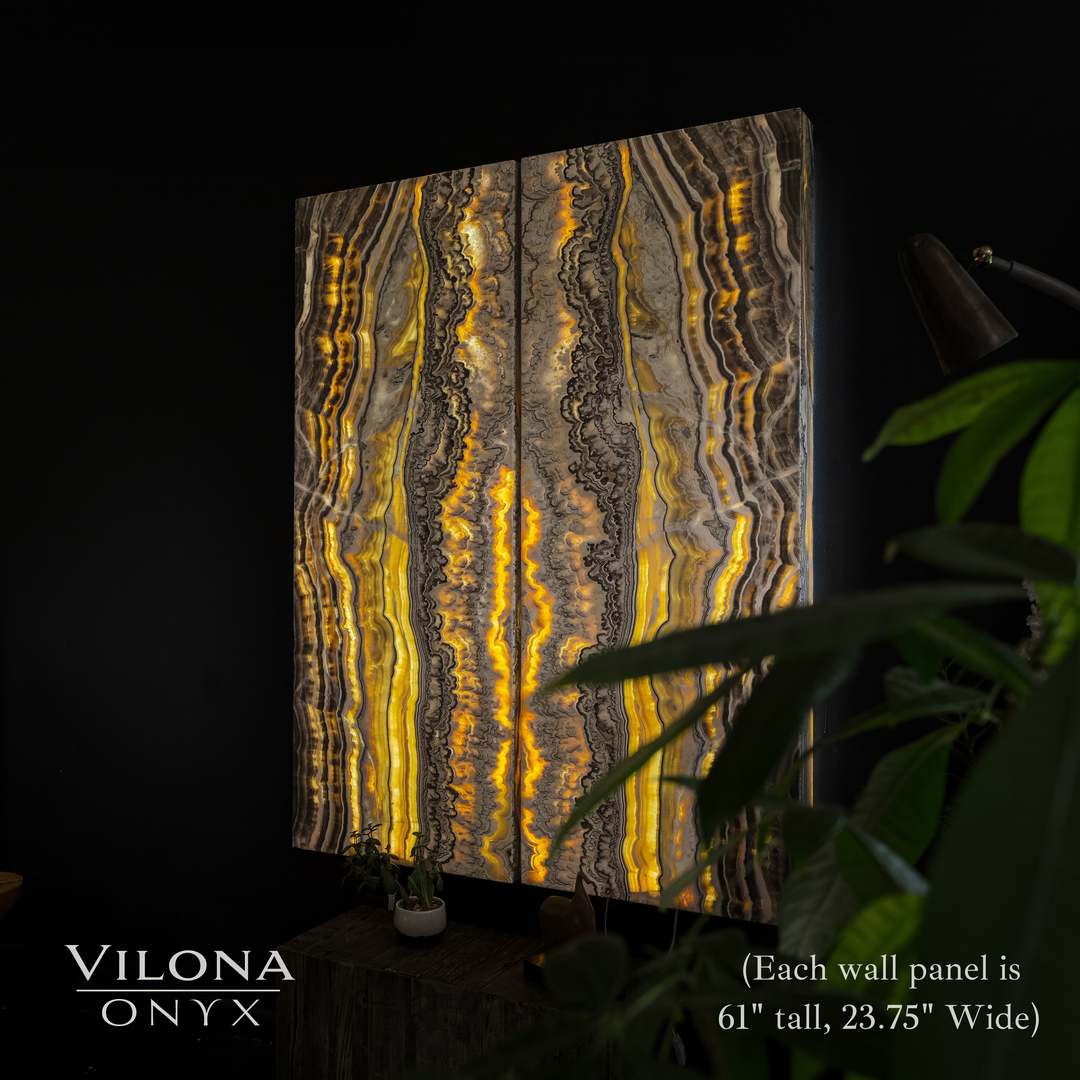 Onyx wall panel with golden, gray, and black vertical swirl patterns and backlit glow.