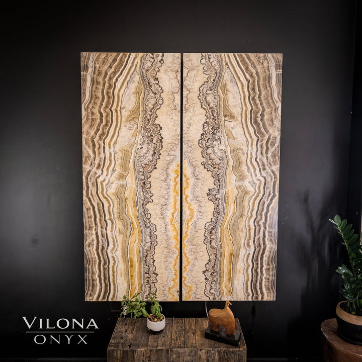 Onyx-style wall panel set with beige and gold swirled stone veining, vertical rectangles.