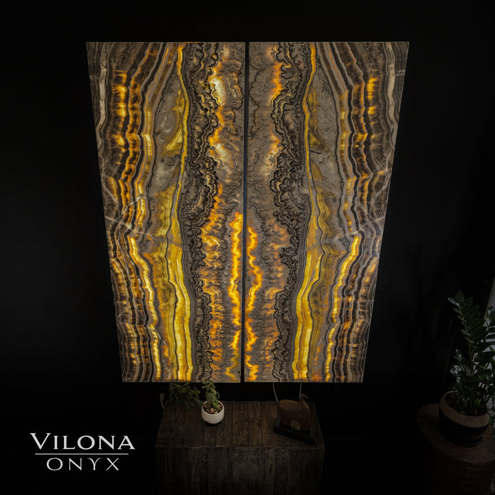 Onyx wall panel with golden amber veins, dark outlines, and vertical glowing striations.