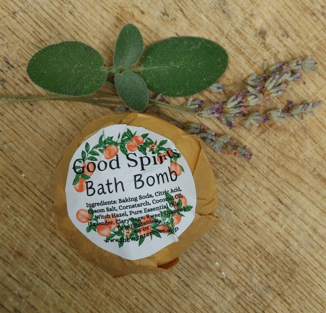 Good Spirits bath bomb label on round brown wrapper with dried botanical sprigs