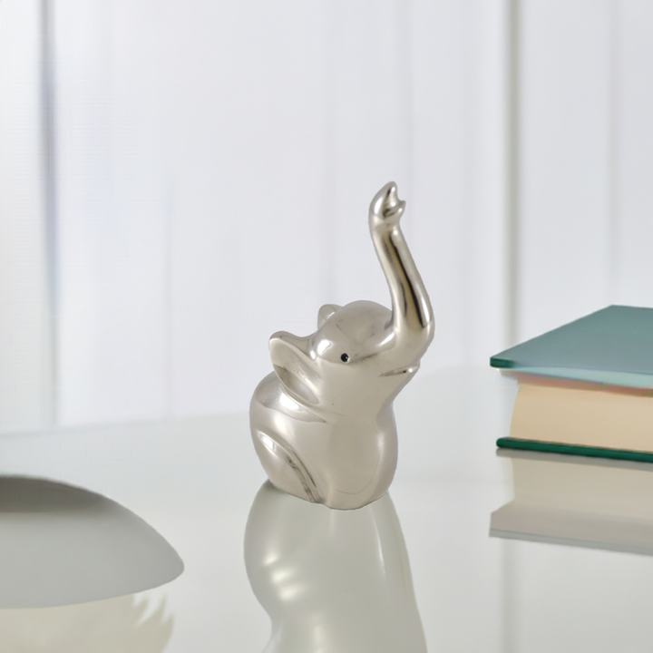 Silver elephant ring holder figurine on display with raised trunk
