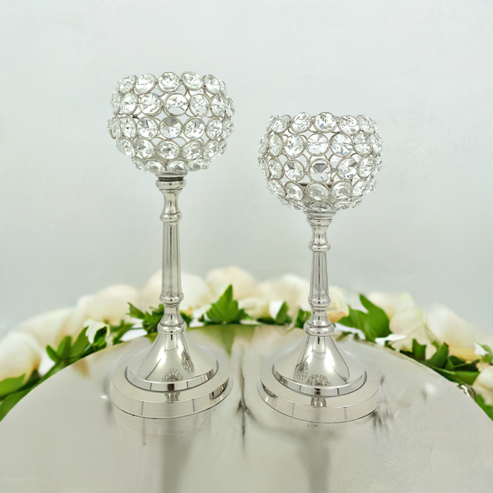 Two silver crystal candle holders with round bases and clear beaded hurricane shades