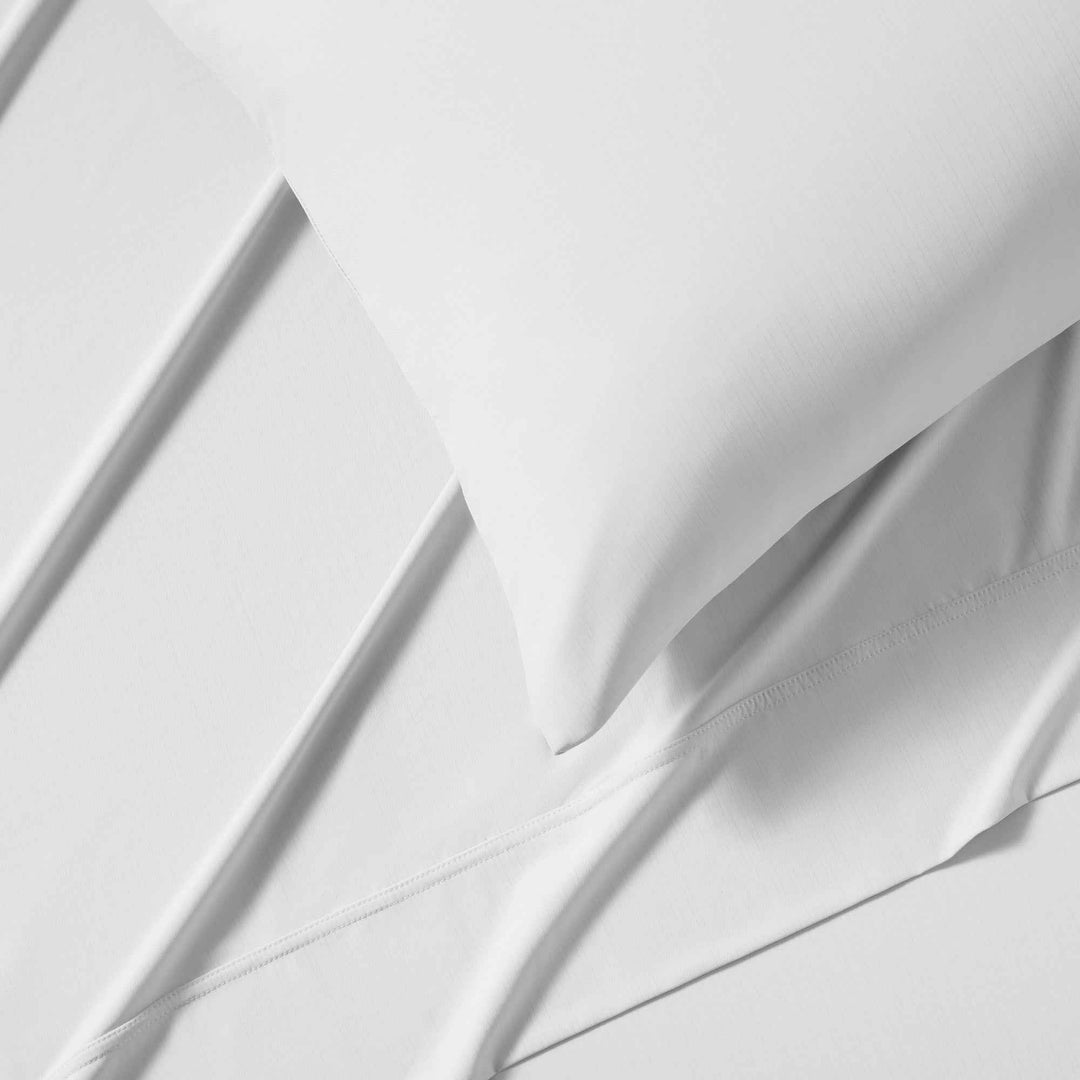 White sheet and pillowcase corner seam with stitched edge detail