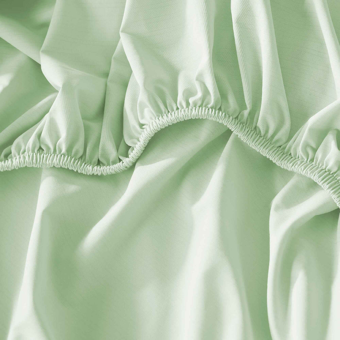 Light green elasticated sheet hem with gathered fabric edge for a snug fit