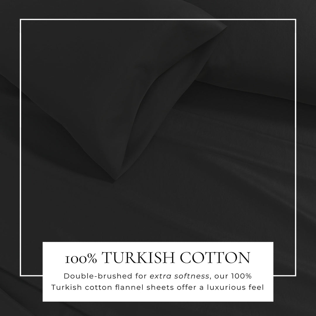 Cotton solid flannel sheet fabric close-up in dark black, smooth wrinkle texture