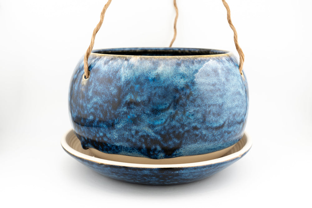Glazed hanging planter with rope handles and round saucer base, deep blue