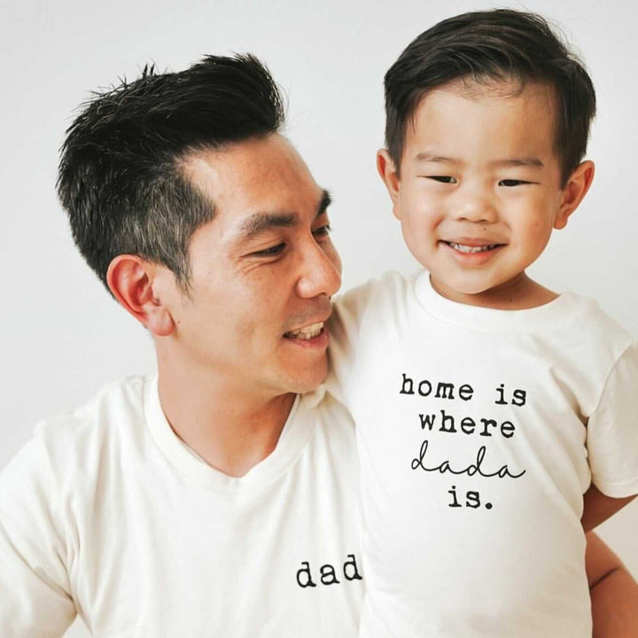 Kids organic T-shirt in cream on child, front 'home is where dada is' print.