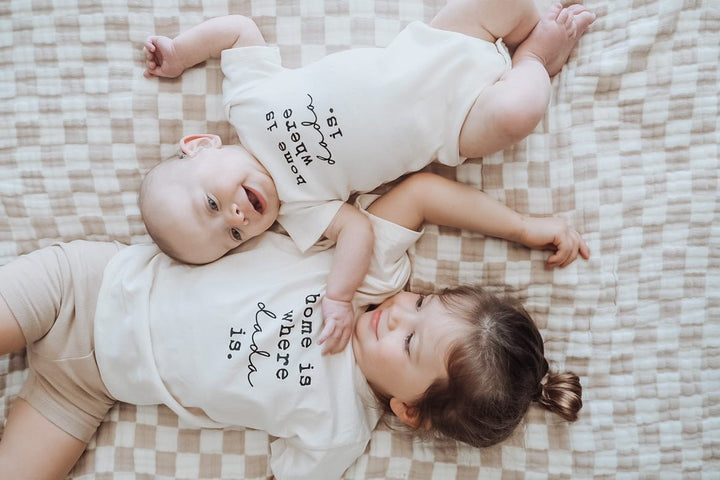 Kids organic T-shirt, cream; 'home is where dada is' print on two children.