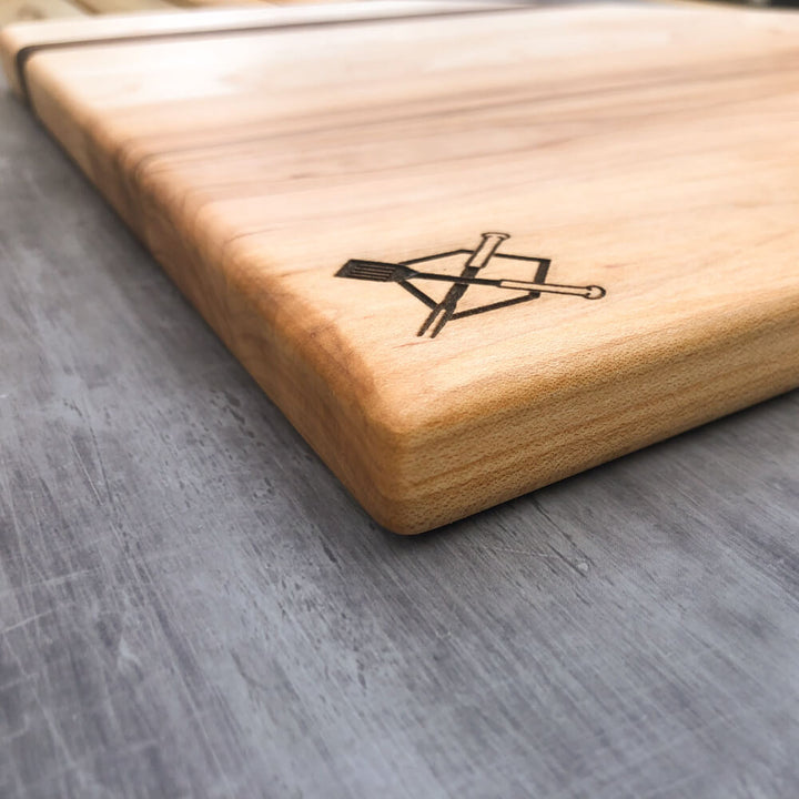 Home plate cutting board corner view, rounded edge, engraved crossed logo in black