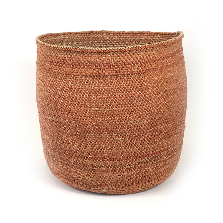Tall round woven basket, rust-brown with braided rim and open mouth