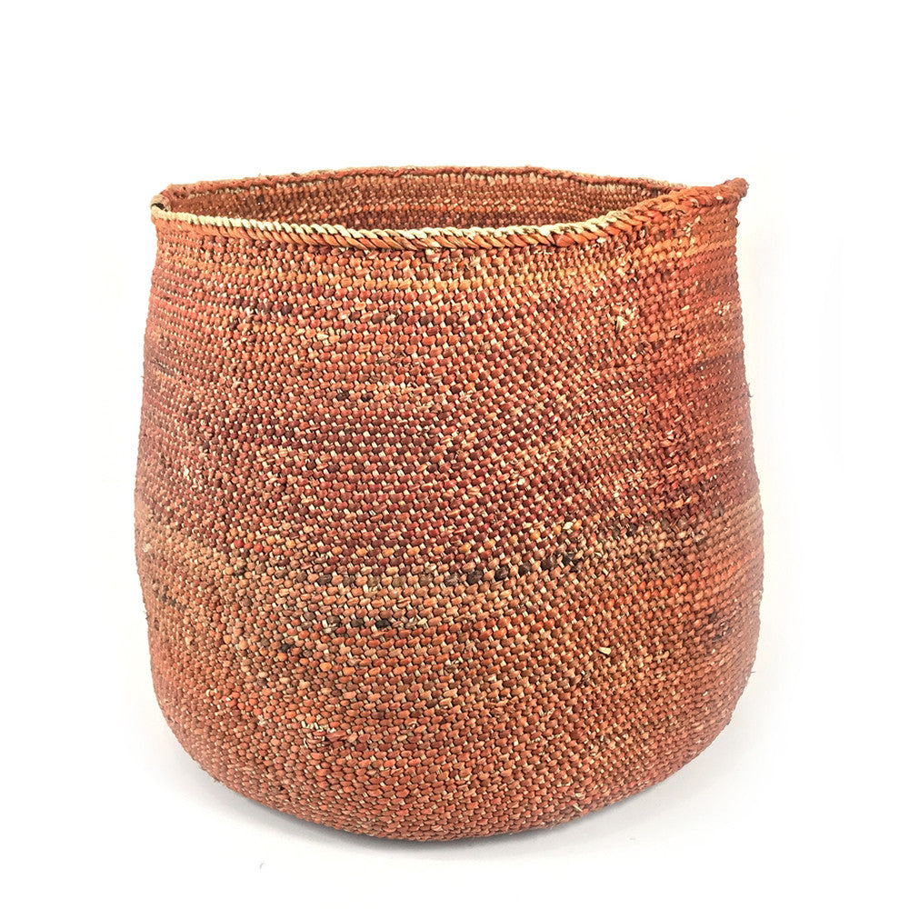 Woven round storage basket in rust-brown with thick rim, open top