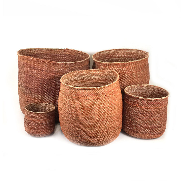 Set of four woven baskets in rust-brown, nesting sizes with open tops
