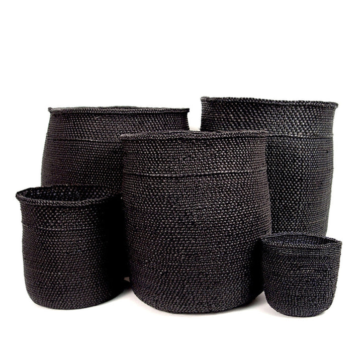 Set of dark woven baskets in three heights, matching stacked cylinder shapes