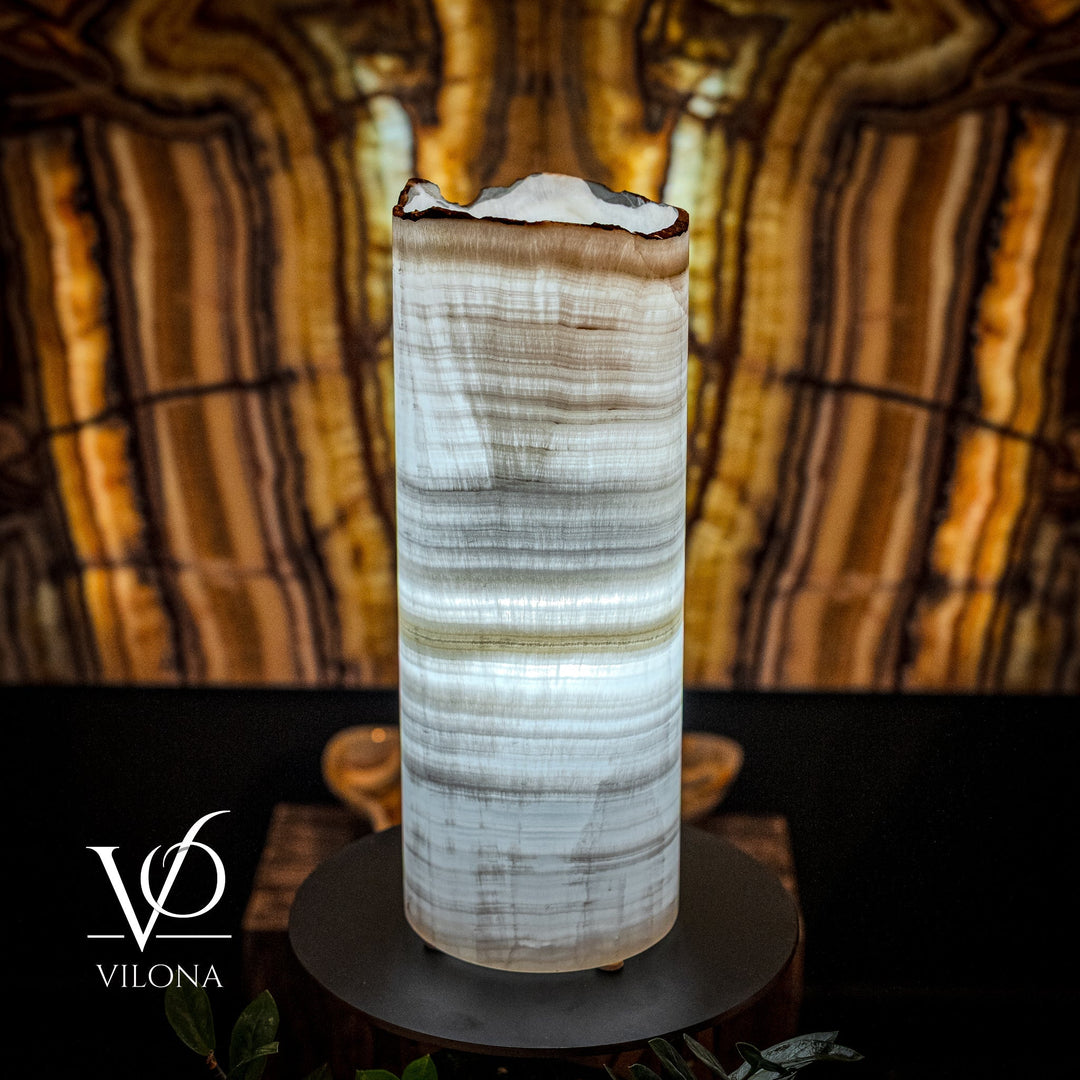 White onyx table lamp cylinder with carved swirls, set on black round base