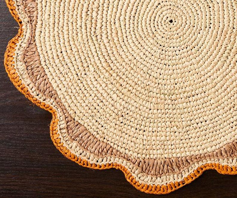 A handwoven Raffia Placemat in Tan, Orange & Brown