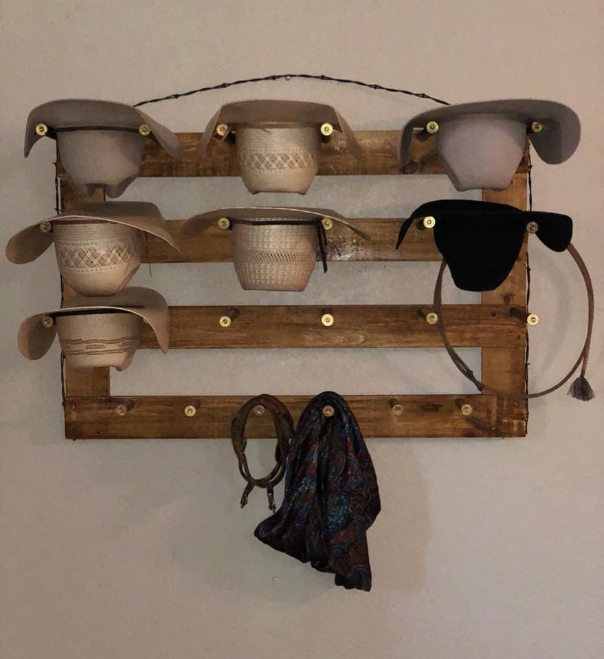 Horizontal wall hat organizer with rustic wood frame and multiple cup-style hat holders