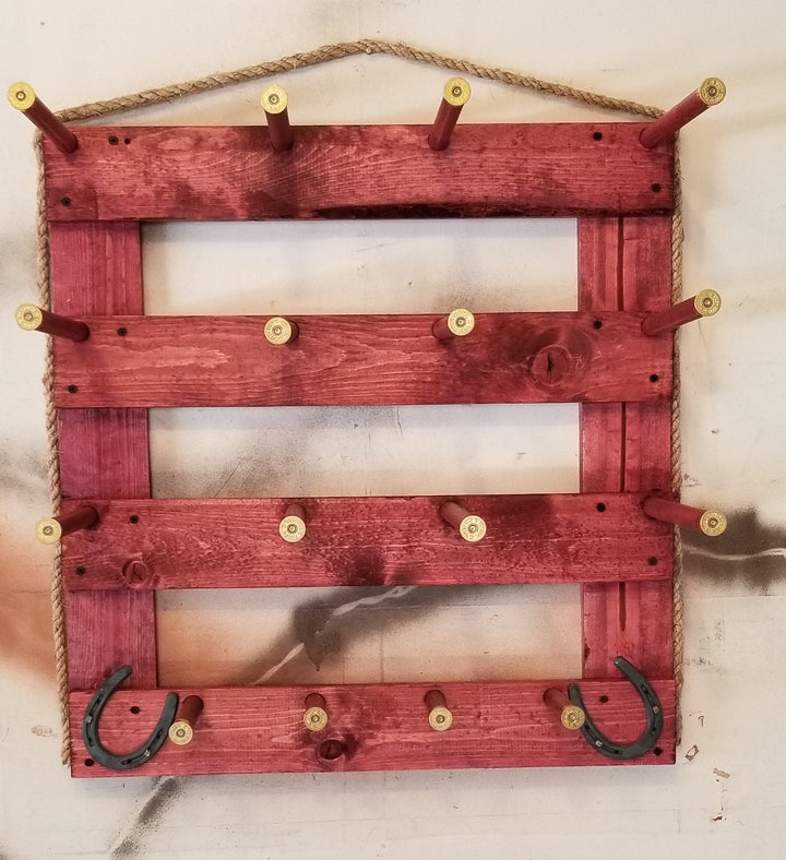 Red rustic wooden wall organizer with three empty shelf panels and metal pegs plus two U hooks