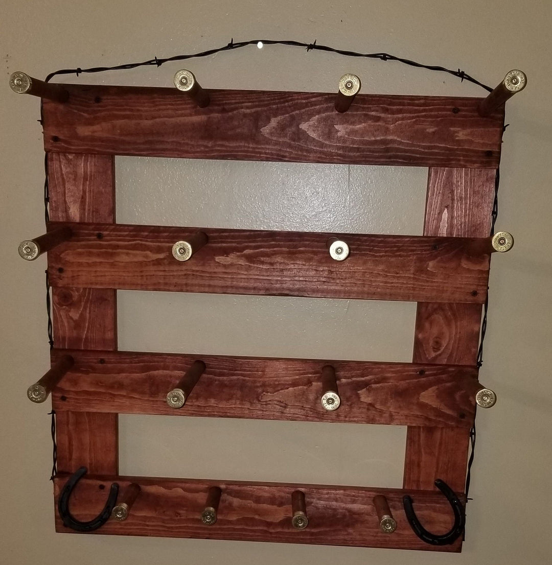 Dark brown wooden wall organizer with four empty panels, metal peg knobs, two U hooks, and cord