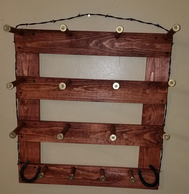Dark brown wooden wall organizer with four empty panels, metal peg knobs, two U hooks, and cord