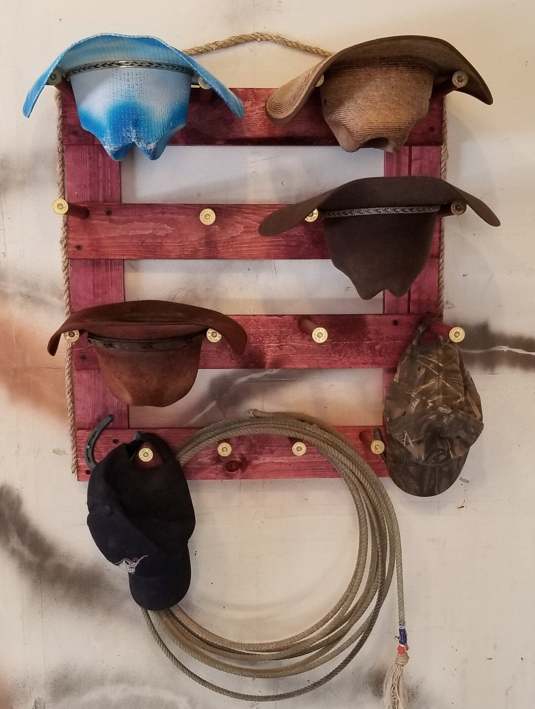 Wooden wall hanging organizer in dark red with multiple leather accessory pockets and metal pegs