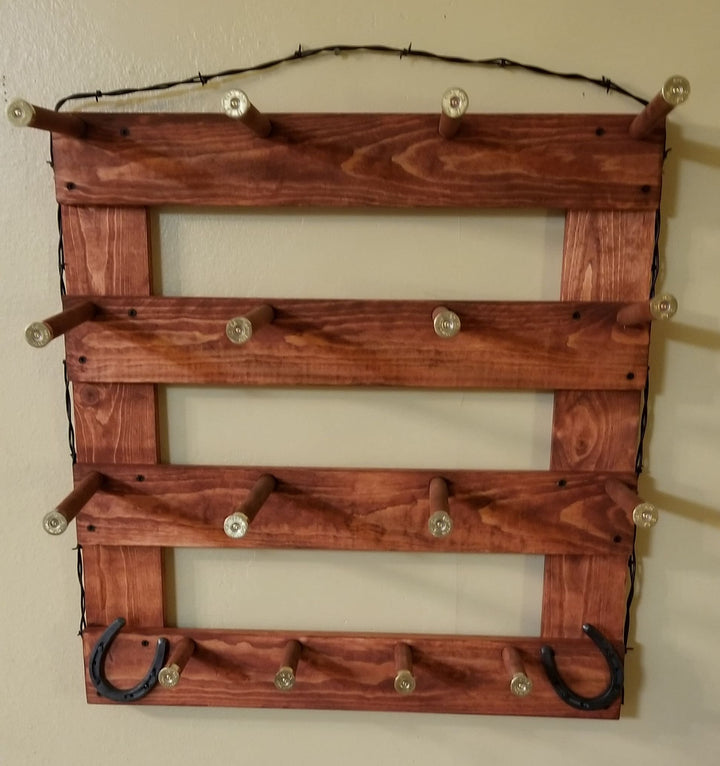 Brown wooden wall organizer with four open compartments, metal peg knobs, and two U hooks