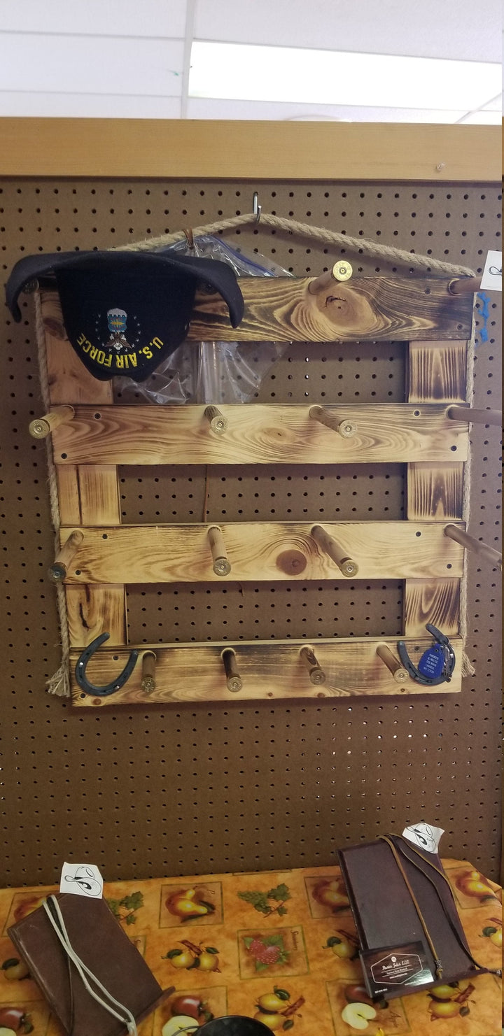 Rustic wooden wall organizer with open compartments and metal peg hooks; hanging frame and straps